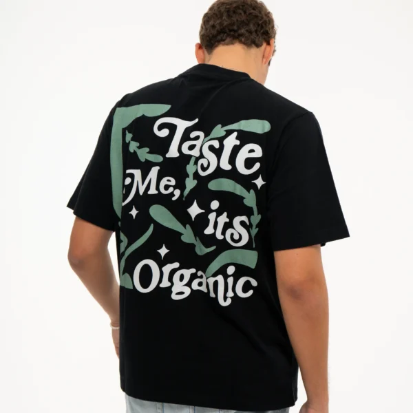 Back shot in movement of model Gustavo from the Dropout brand wearing the Organic Taste Black T-shirt