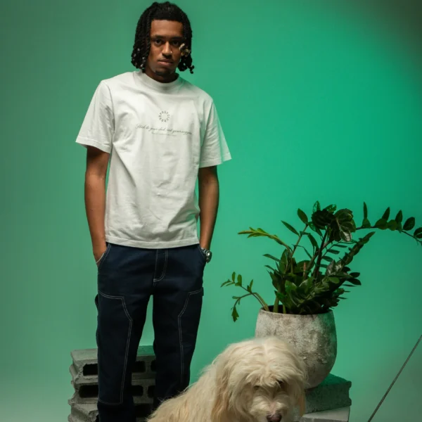 Flacko wearing Dropout's Organic Taste White T-shirt next to a white dog