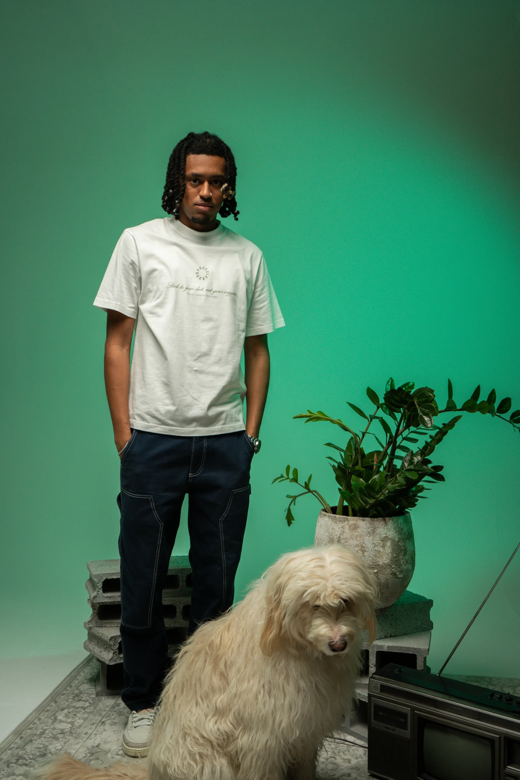 Flacko wearing Dropout's Organic Taste White T-shirt next to a white dog