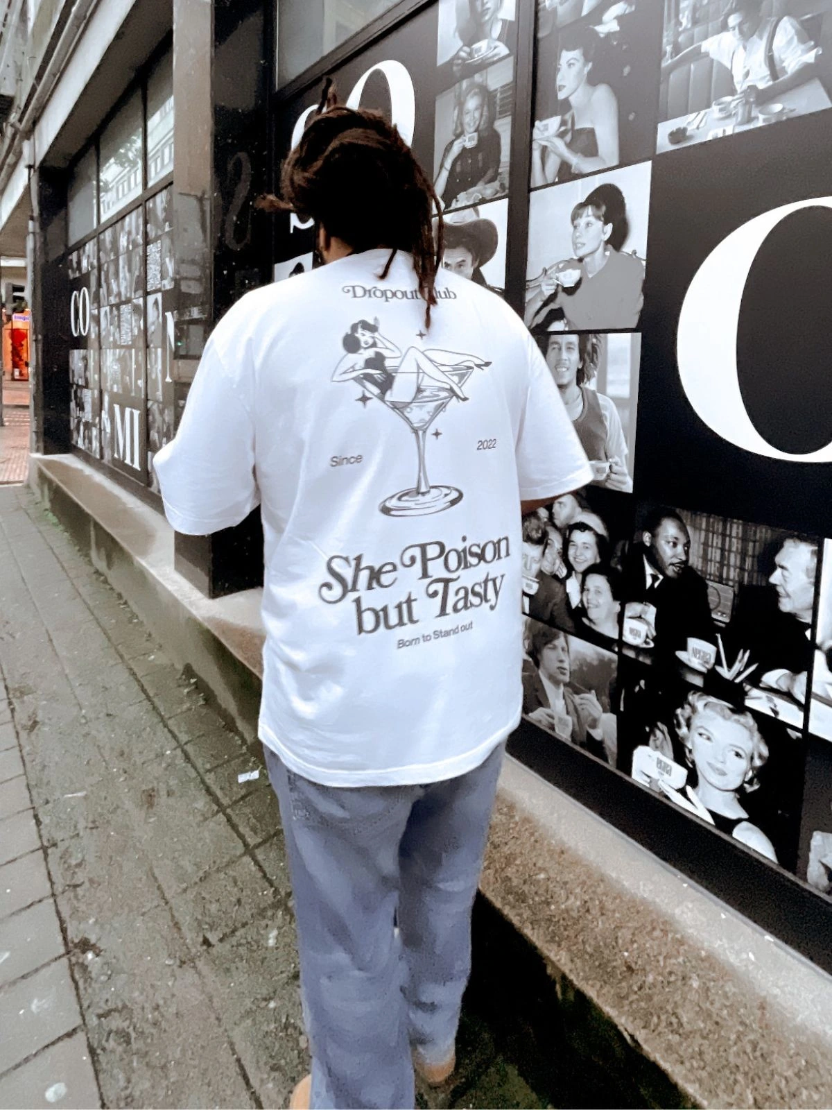 Freddy walking down the street with the Tasty Poison White T-shirt from the Dropout brand